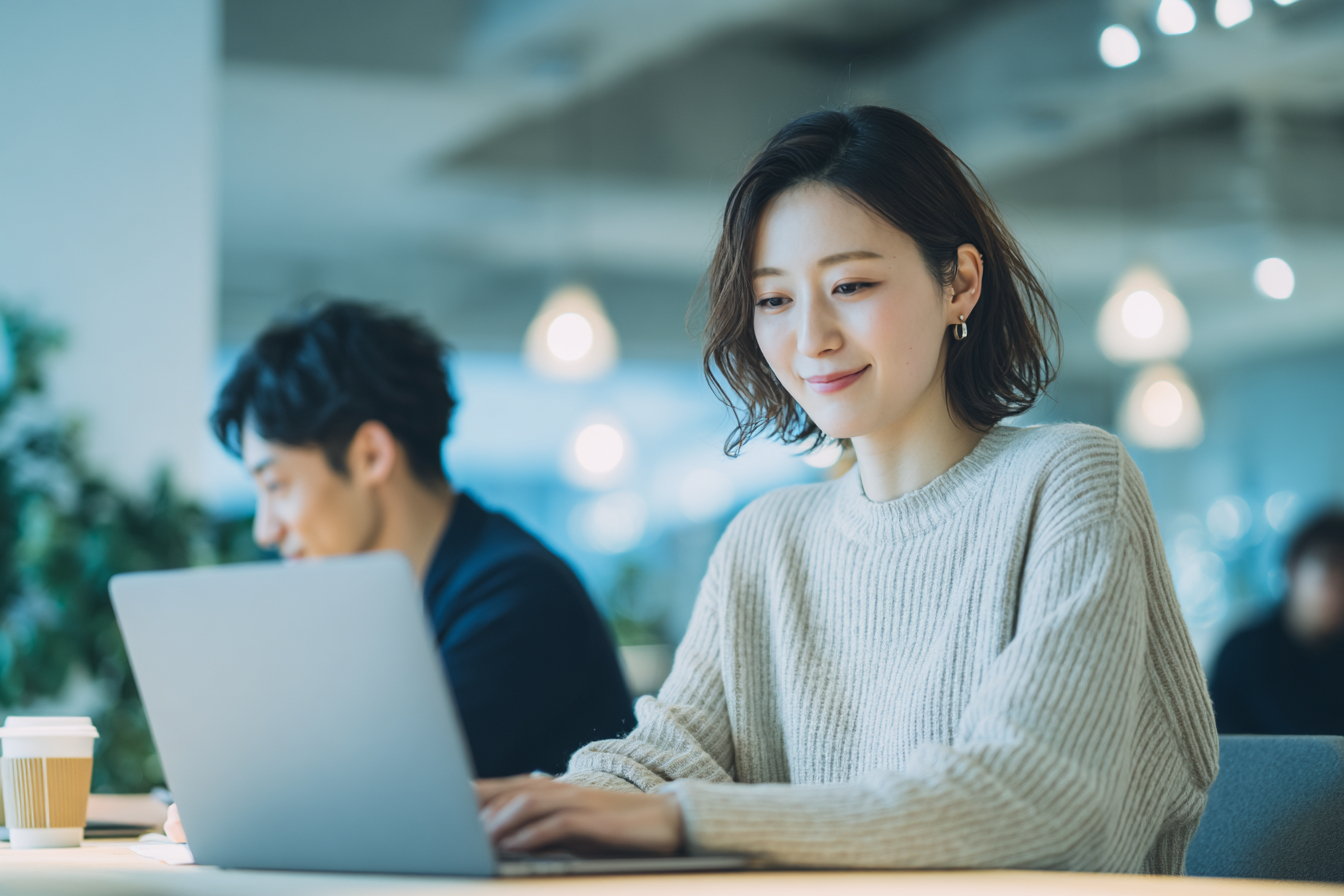 Focused woman working on laptop.png
