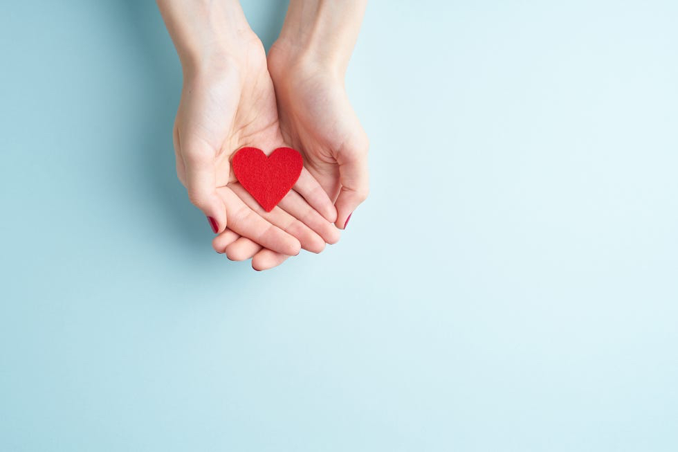 a-person-holding-red-heart-in-hands-donate-and-royalty-free-image-1629037397.jpg