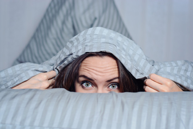 frontal-portrait-of-a-lonely-woman-with-a-blanket-on-her-head-suffering-from-insomnia_108611-654.jpg