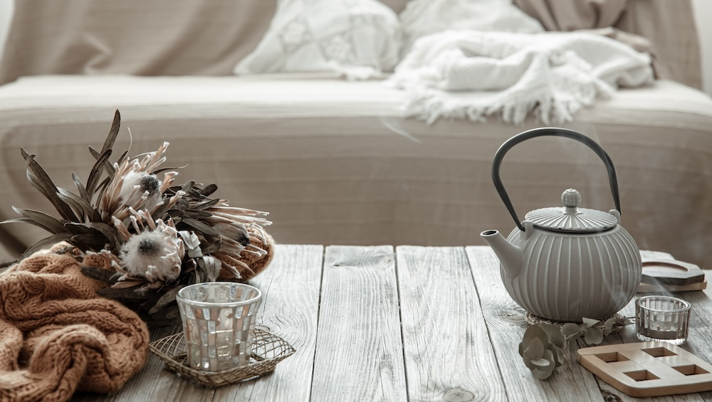 teapot-with-tea-and-candles-on-the-wooden-table-2023-11-27-05-34-49-utc.jpg