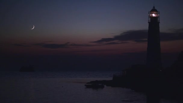 stock-video-young-moon-after-sunset-at-ocean-near-old-lighthouse-and-sunken-ship.jpg