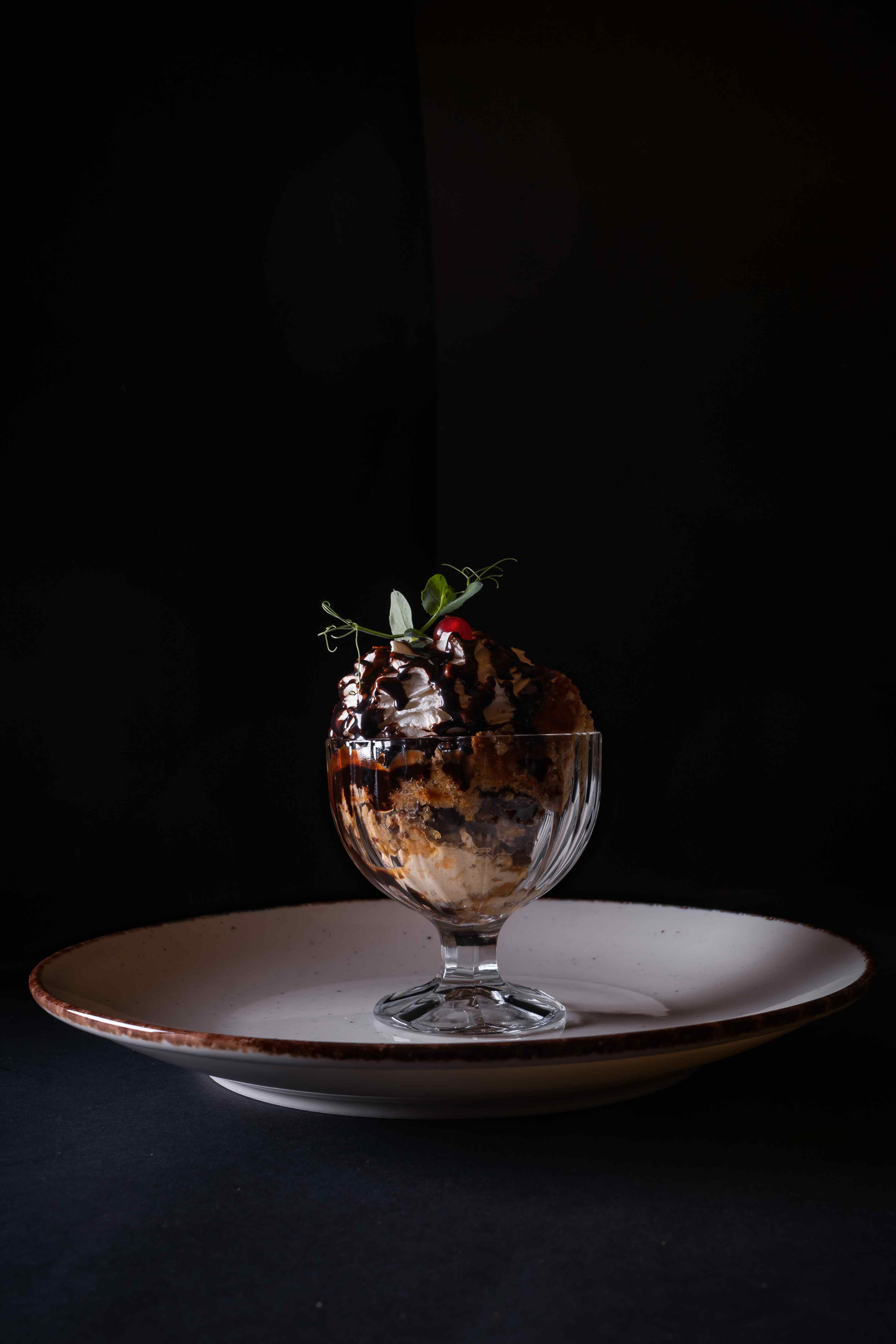 vertical-shot-glass-delicious-ice-cream-with-chocolate-syrup-whipped-cream.jpg