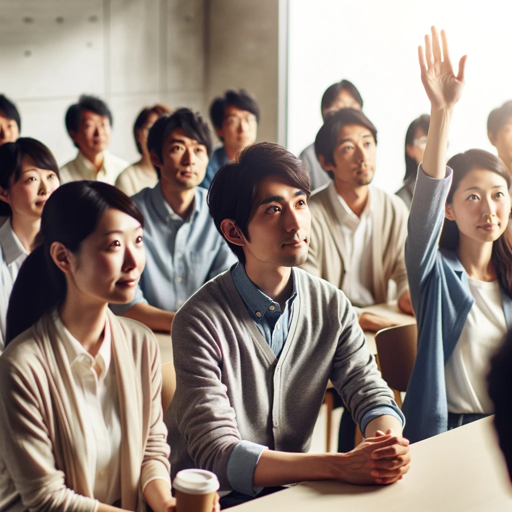 DALL·E 2024-02-06 10.52.05 - A group of Japanese people engaged in a discussion, with one person raising their hand to ask a question. The group is diverse, including men and wome.png