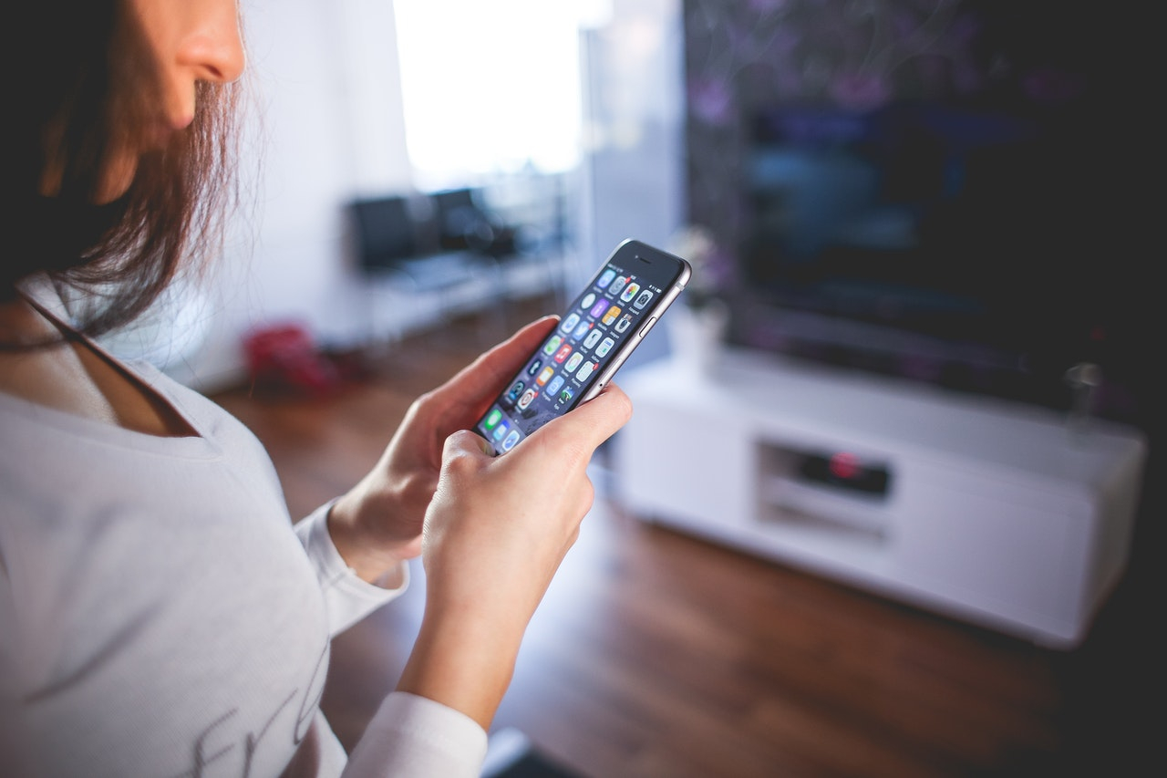 woman-wearing-white-v-neck-shirt-using-space-gray-iphone-6-225232.jpg