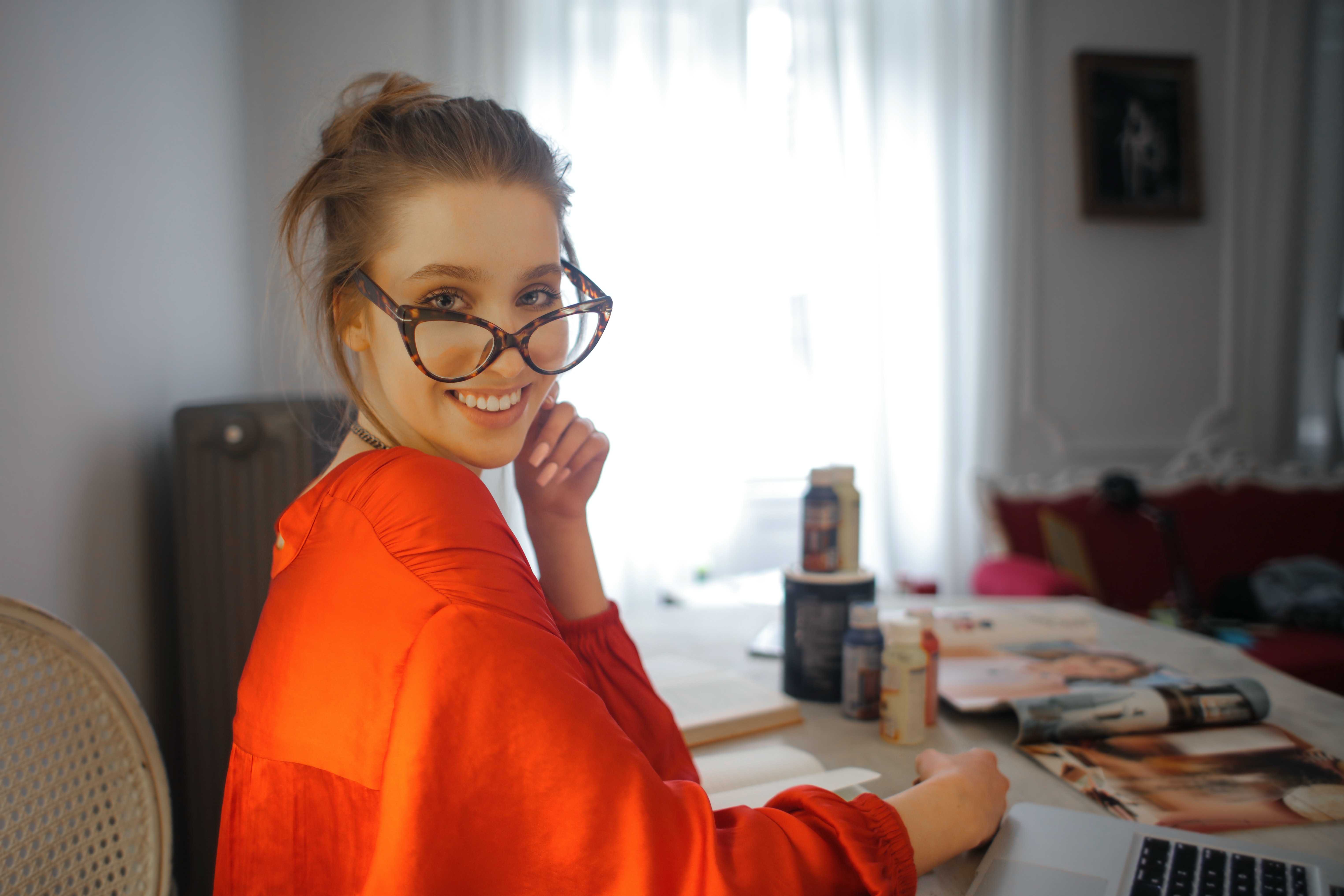 happy-adult-woman-using-laptop-while-chilling-at-home-3765120.jpg
