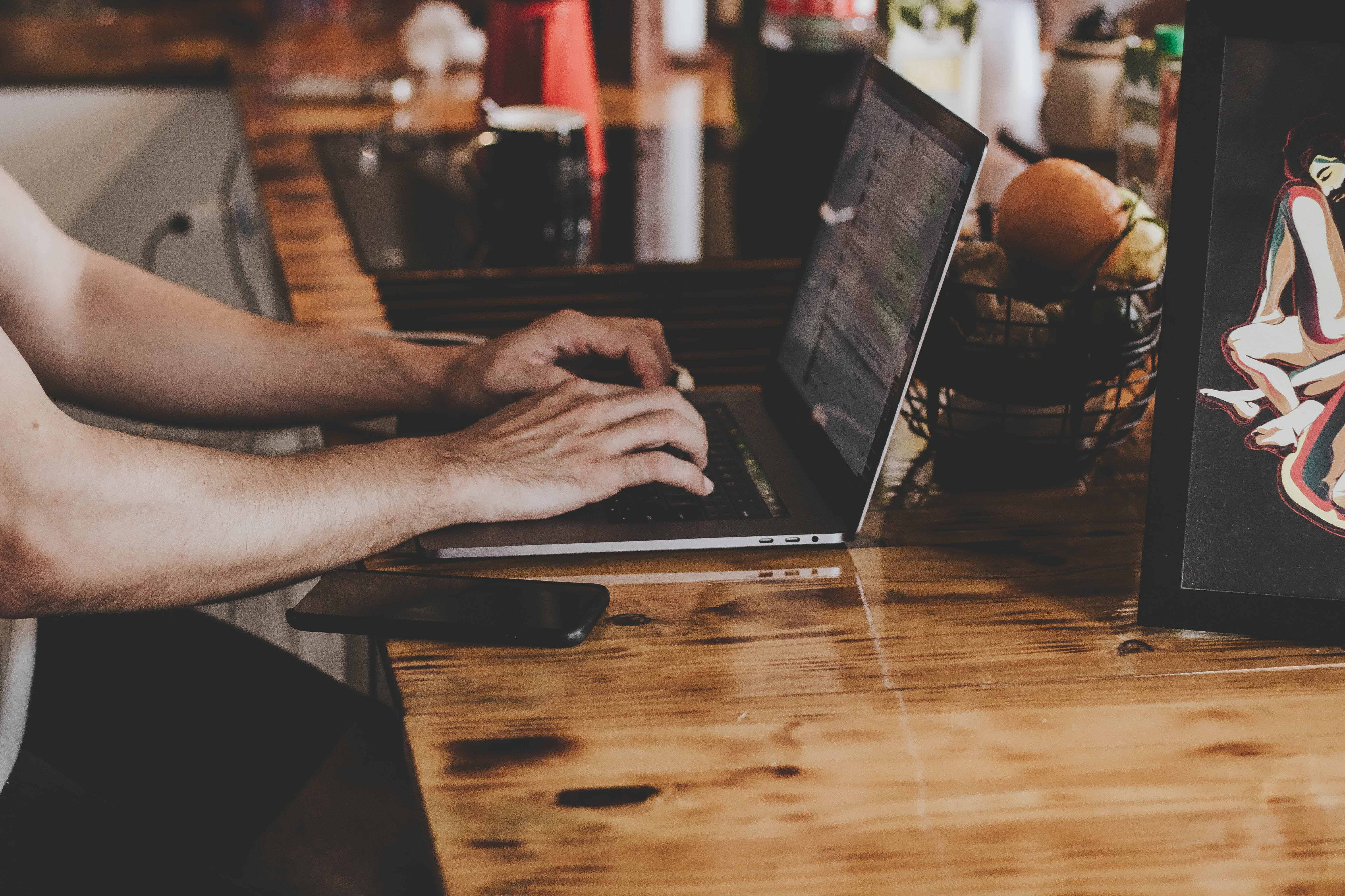 person-in-front-of-laptop-on-brown-wooden-table-2115217 (1).jpg